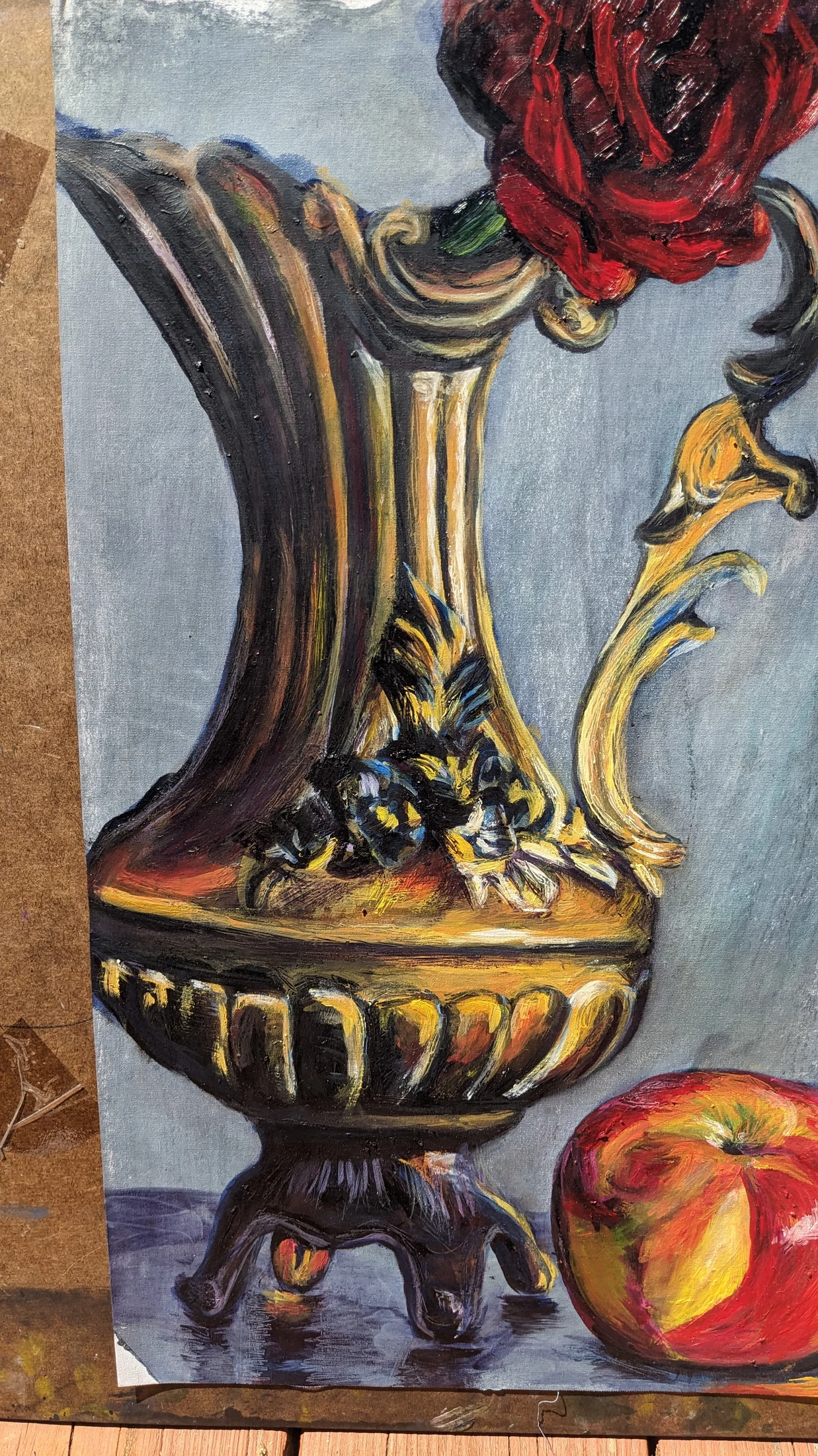 Close detail of the antique brass vase and rose in Echoes of Time
