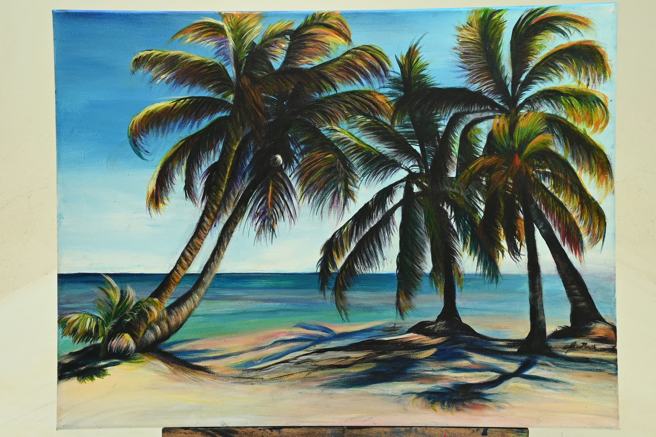 Full view of Palm Tree Ocean Sunset displayed on an easel